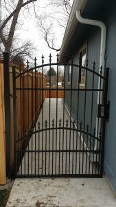 Metal gate with double arch top and spear detail. Small dog security