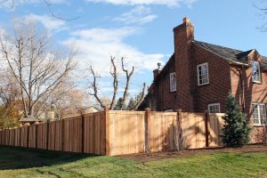 Tongue and groove, privacy fence, cedar wood fence with decorative post caps and a flat cap rail