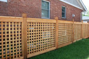 Open weave wooden fence with 6 inch post with groove and bevel top and 6 inch top rail