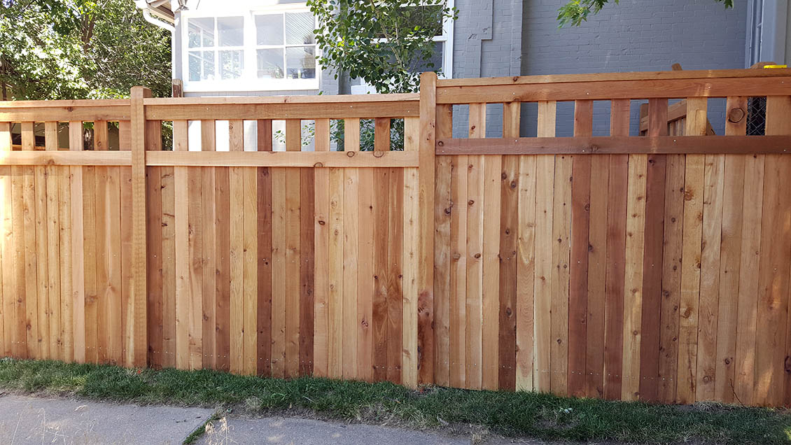 Cedar privacy fence with decorative, open pattern top section and cap rail, Denver, Colorado