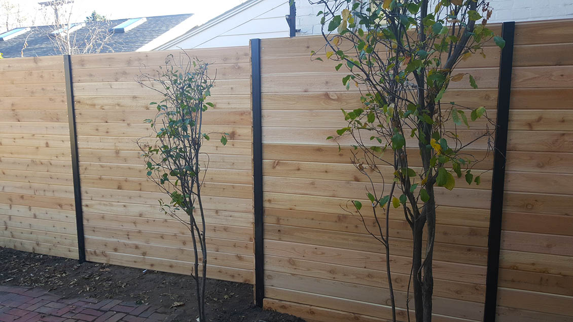Contemporary cedar privacy fence with metal posts