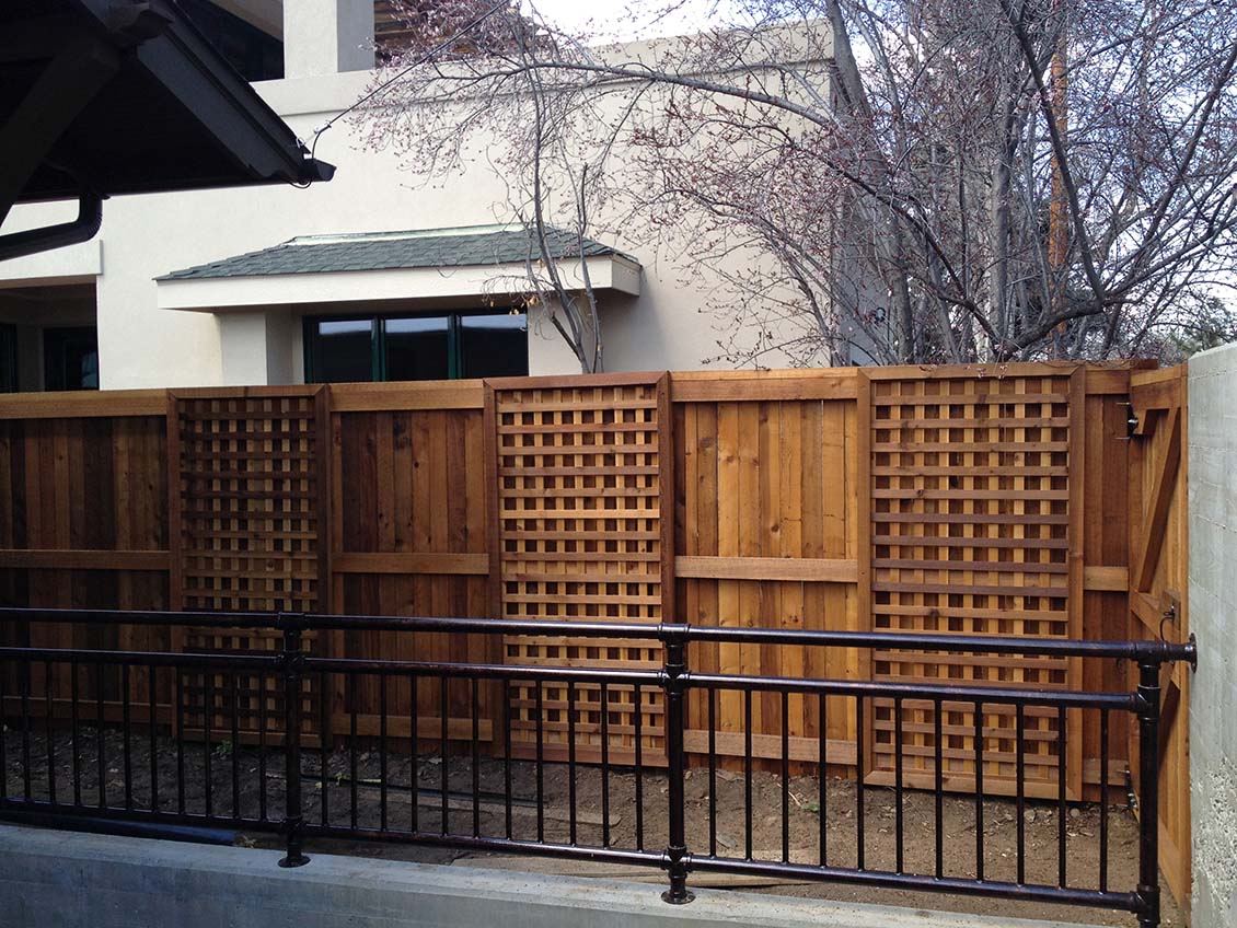 Wood fence with alternating vertical and open weave pattern
