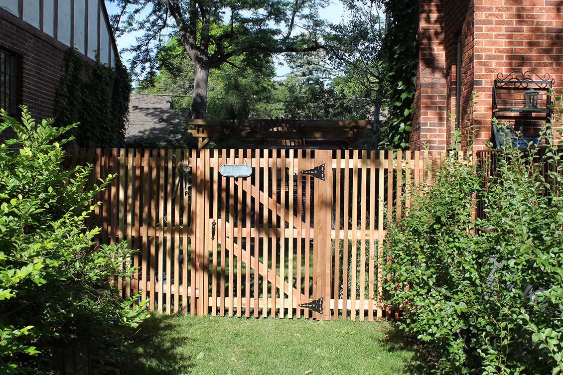 Open vertical picket fence and gate